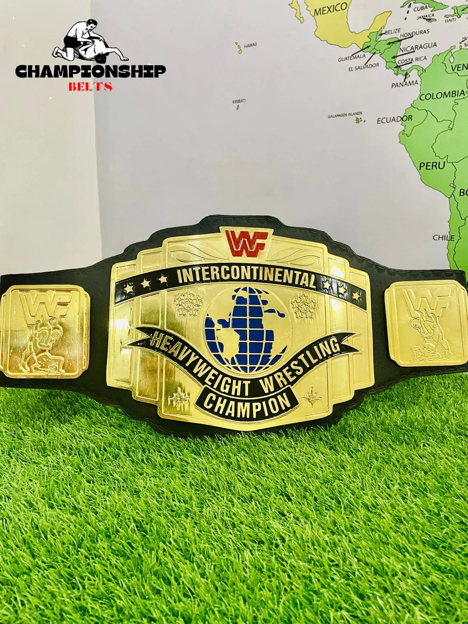 WWF Intercontinental Heavyweight Wrestling Championship belt on grass with a map in the background
